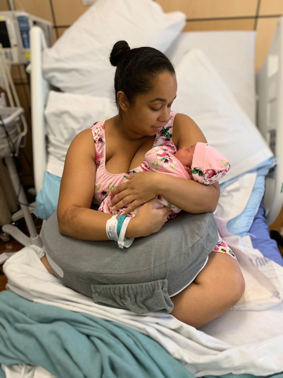 Mom with large chest snuggling newborn baby, inspiring the creation of the Snuggly Mom shirt for comfortable breastfeeding